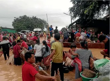  ?? GETTY IMAGES ?? Lao villagers stranded during evacuation from floodwater­s after the XepianXe Nam Noy dam collapsed in Attapeu Province. Hundreds of people were missing.