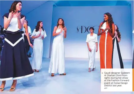  ?? AFP ?? Saudi designer Sadeem Al Shehail (third from right) during her show at the Fashion Forward event at Dubai Design District last year.