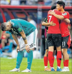  ?? AP PHOTO ?? Germany’s Niklas Suele, left, is dejected as South Korea’s Son Heung-min celebrates after their Group F match Wednesday at the 2018 soccer World Cup in Kazan, Russia.