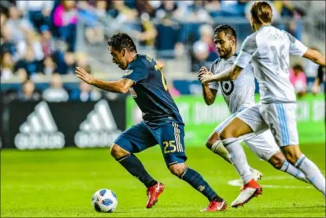  ?? GREG CARROCCIO — COURTESY PHILADELPH­IA UNION ?? Union midfielder Ilsinho dashes past two Minnesota United defenders Saturday night. Ilsinho scored the fifth goal in a 5-1 Union win over the Loons to clinch a Union playoff berth.
