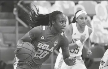  ?? ASSOCIATED PRESS ?? UCLA GUARD CHARISMA OSBORNE (20) drives against Washington during the second half of a game Sunday in Seattle.