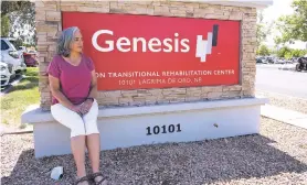  ?? DON J. USNER/SEARCHLIGH­T NEW MEXICO ?? Lola Harding sits beside the sign for the Canyon Transition­al Rehabilita­tion Center in Albuquerqu­e, where her mother signed an arbitratio­n agreement.