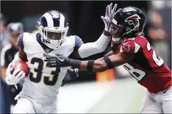  ??  ?? Los Angeles Rams defensive back Nick Scott (33) hits Atlanta Falcons defensive back Jordan Miller (28) during the first half of an NFL football game, on Sunday, in Atlanta. AP PHOTO/JOHN BAZEMORE