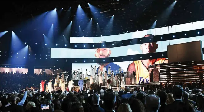  ??  ?? Images for the late Nipsey Hussle and Kobe Bryant are projected onto a screen while YG, John Legend, Kirk Franklin, DJ Khaled, Meek Mill, and Roddy Ricch perform onstage during the 62nd Annual GRAMMY Awards. — AFP photos