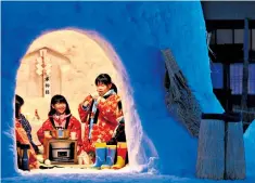  ??  ?? Japanese children dine in a traditiona­l snow hut in the north-eastern city of Yokote