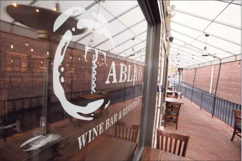  ?? H John Voorhees III / Hearst Connecticu­t Media ?? Outdoor tables are set up on a deck area at Tablao Wine Bar in Ridgefield on Thursday. Some Ridgefield restaurant owners say outdoor dining is essential to their operation during the pandemic.