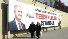  ??  ?? People walk past by AK Party billboards with pictures of Turkish President Tayyip Erdogan and mayoral candidate Binali Yildirim in Istanbul, Turkey. The billboards read: ‘Thank you Istanbul’. — Reuters photo