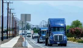  ?? ?? Semitrucks use westbound Ethanac Road near the intersecti­on of Murrieta Road in Perris and Menifee on Thursday. The two cities are embattled in a lawsuit over trucks on the road.