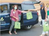  ?? ORLAND PARK PUBLIC LIBRARY ?? Outreach services assistants Mary Lynn Maloney, from left, Theresa Marketti and Duke Phelps load books for the Orland Park Public Library’s home delivery service.