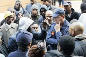  ?? PICTURE: MICHAEL WALKER ?? Uber head of communicat­ions Joseph Munzvenga tells a police officer drivers’ concerns at Uber offices at The Foundry in Green Point.