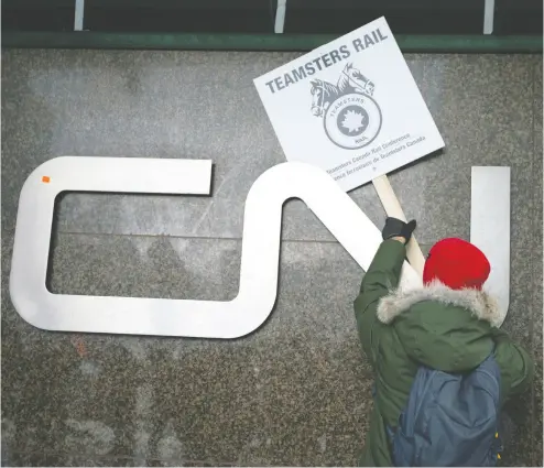  ?? Christine Muschi / reuters files ?? A Teamsters Canada union member pickets outside the headquarte­rs of Canadian National Railway in Montreal as a strike at CN by 3,200 conductors, train and yard workers has put a crimp in rail-shipped propane supplies.