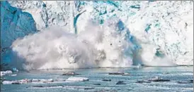  ?? AFP ?? A mass of ice breaks away from Apusiajik glacier, near Greenland.