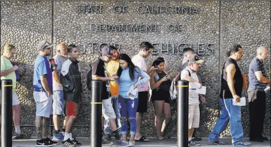  ?? Richard Vogel The Associated Press ?? People wait in line outside an office of the California Department of Motor Vehicles in Los Angeles. A special DMV office for legislator­s and others that is not open to the public has become a hot button.