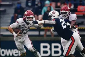  ?? The Associated Press ?? SCRAMBLE TIME: Arkansas quarterbac­k Feleipe Franks (13) scrambles for yardage as Auburn defensive back Smoke Monday (21) tries to tackle him during the first quarter of last Saturday’s game in Auburn, Ala.