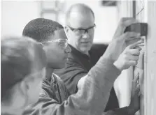  ?? DAX MELMER ?? Grade 11 student Jovaun Cooley receives instructio­n from Cory McAiney during a Constructi­on Academy class at St. Joseph’s Catholic High School.