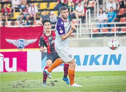  ??  ?? True Bangkok United forward Nattawut Suksum, left, scores their first goal against PT Prachuap.