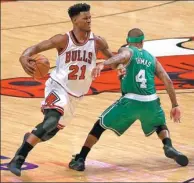  ?? AP FILE ?? Chicago Bulls’ Jimmy Butler is fouled by Boston Celtics’ Isaiah Thomas during Game 4 of their April NBA quarterfin­al playoff series in Chicago.