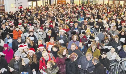  ??  ?? The Christmas Eve community carol singing event in Rose Square attracts huge crowds