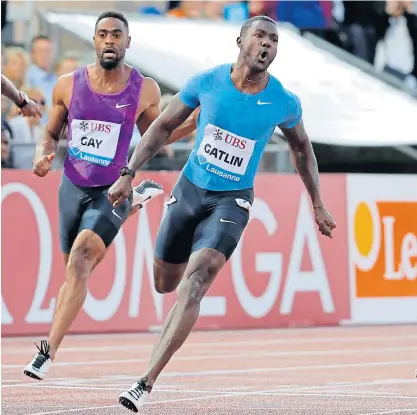  ??  ?? Justin Gatlin, right, celebrates victory in Lausanne.