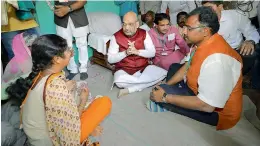  ?? — PTI ?? BJP national president Amit Shah visits the house of a farmer, Shivaraj Basalingap­pa Alreddy, who committed suicide at Mangalgi Village, in Bidar on Sunday.