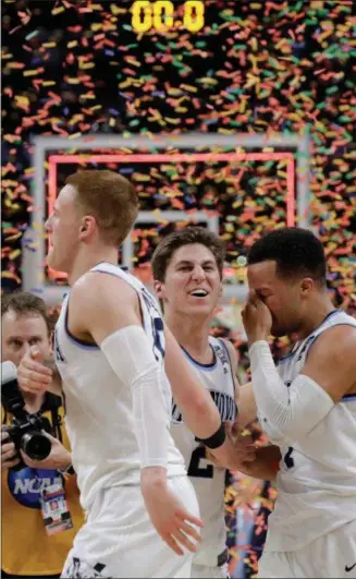  ?? DAVID J. PHILLIP — ASSOCIATED PRESS ?? Villanova’s Donte DiVincenzo, left, Collin Gillespie and Jalen Brunson celebrate defeating Michigan, 79-62, on April 2 in San Antonio.