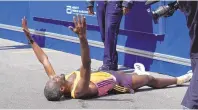  ?? ASSOCIATED PRESS ?? Sisay Lemma of Ethiopia celebrates while lying down after winning the Boston Marathon on Monday.