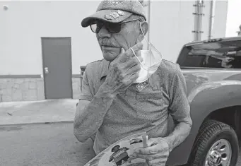  ?? Jerry Lara/Staff photograph­er ?? George Rodriguez, 72, carries photograph­s of his late stepgrands­on, Jose “Josécito” Flores, during his pizza delivery runs in Uvalde. He delivers pizzas to keep from crying.