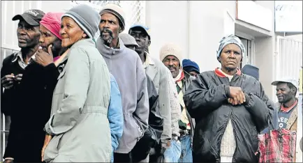  ?? Picture: BHONGO JACOB ?? ANYTHING WILL DO: Kholeka Witbooi, right, stands outside a retail store in a long queue with other senior citizens from Komani who beg for 20c coins every Friday