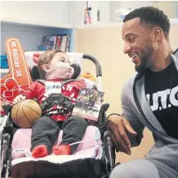  ?? STEVE RUSSELL TORONTO STAR FILE PHOTO ?? Forward Norman Powell visited Isabella Marcello, who at 8 months old has spent her entire life at Sick Kids, in January.