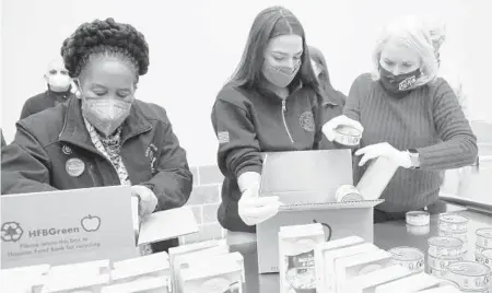  ?? ELIZABETH CONLEY/HOUSTON CHRONICLE ?? Democratic Reps. Sheila Jackson Lee of Texas, left, Alexandria Ocasio-Cortez of New York and Sylvia Garcia of Texas distribute food Saturday at the Houston Food Bank in Texas, which is recovering from extreme weather.