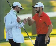  ?? Charles Krupa / Associated Press ?? Matthew Wolff (right) bumps fists with his caddie, Nick Heinen, after his thirdround 65 Saturday.