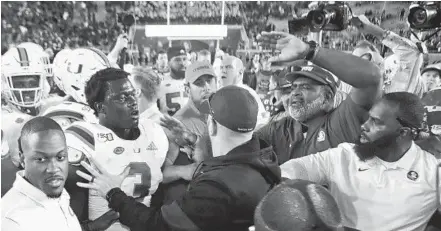  ?? /PHIL SEARS/AP ?? Miami and Florida State players are separated by coaches as they skirmish after a game on Nov. 2, 2019, in Tallahasse­e.