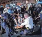  ?? JOHN MINCHILLO/AP FILE ?? A protester is arrested by NYPD officers during a march on June 4, 2020, following the death of George Floyd.