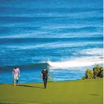  ?? CLIFF HAWKINS GETTY IMAGES ?? Patrick Reed and caddie Kessler Karain walk 11th green prior to the Sentry Tournament of Champions in Lahaina, Hawaii.