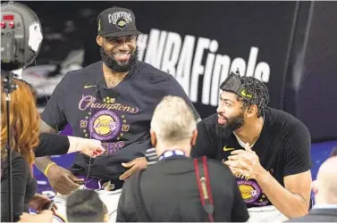  ?? MARK J. TERRILL AP ?? LeBron James (left) is under contract for 2020-21, but Anthony Davis (right) can opt out and become a free agent.