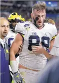  ?? ALAN DIAZ/AP FILE ?? Michigan tight end Jake Butt is helped off the field during the 2016 Orange Bowl.