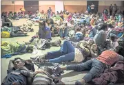  ?? DANIELE VOLPE — THE WASHINGTON POST ?? Honduran migrants rest inside an improvised shelter in Esquipulas, Guatemala.