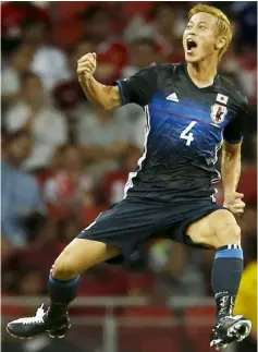  ??  ?? Keisuke Honda celebrates a goal against Singapore during their 2018 World Cup Group E qualifying match at the National Stadium in Singapore in this Nov 12, 2015 file photo. — Reuters photo