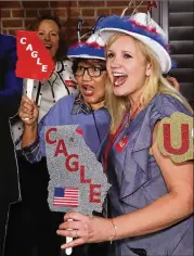  ?? CURTIS COMPTON/CCOMPTON@AJC.COM ?? Thu Van (left) and Tricia Hise cheer for Lt. Gov. Casey Cagle at his election night watch party Tuesday night in Gainesvill­e. Cagle faced attacks from his Republican rivals.