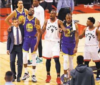  ?? Scott Strazzante / The Chronicle ?? The Warriors’ Kevin Durant (second from left) is helped off the court by Rick Celebrini, the team’s director of sports medicine, who had weighed in on Durant’s decision to play in Game 5.