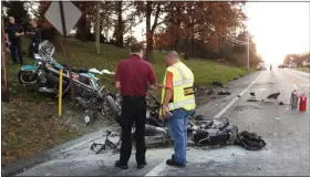  ??  ?? Acting Berks County Coroner Jonn M. Hollenbach confers with some of his deputies at the scene of a fatal crash on Route 183 in Penn Township that involved a car and several motorcycle­s.