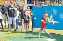  ?? MATIAS J. OCNER/COURTESY ?? Leonardo Gattorno, 5, from Kendall, bats a ball during FanFest at Marlins Park. Spring training opens Wednesday.