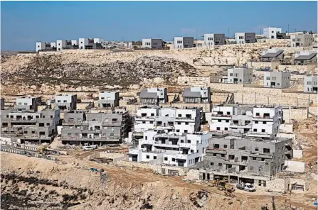  ?? ARIEL SCHALIT/AP 2019 ?? Peter Beinart is a prominent voice among progressiv­es. Above, a housing project in the West Bank settlement of Naale.