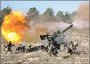  ?? (AP/Ukrainian Defense Ministry press office) ?? Ukrainian and Canadian troops conduct training exercises Thursday near Lviv in western Ukraine to prepare for large-scale internatio­nal military drills this summer. Russia says its troop buildup on the border with Ukraine is a response to security threats posed by the presence of NATO forces.