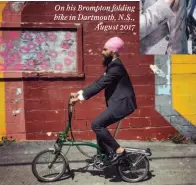 ??  ?? On his Brompton folding bike in Dartmouth, N.S., August 2017