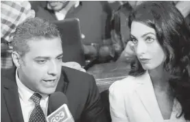  ??  ?? Canadian Al-Jazeera journalist Mohammed Fahmy, and his lawyer, Amal Clooney, speak to media before the verdict in a courtroom in Tora prison in Cairo on Saturday.