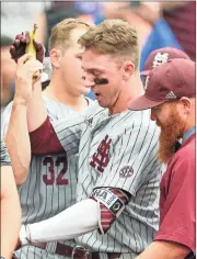  ?? / AP - Nati Harnik ?? Mississipp­i State designated hitter Jordan Westburg is given a banana at the dugout after hitting a grand slam in the second inning of Tuesday’s game.