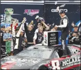  ?? Associated Press ?? Kyle Busch (front right) celebrates in Victory Lane after winning a NASCAR Cup Series race at Talladega Superspeed­way, Sunday, in Talladega, Ala.