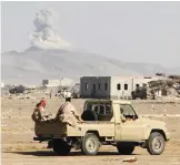  ??  ?? Smoke billows in the distance as Yemeni pro-government forces patrol during clashes against Shiite rebels in Yemen’s western Dhubab district, about 30 km north of the strategic Bab al-Mandab Strait yesterday. — AFP