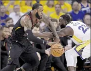  ?? AP/MARCIO JOSE SANCHEZ ?? LeBron James of the Cleveland Cavaliers drives against Draymond Green of the Golden State Warriors during Game 1 of the NBA Finals on Thursday night.